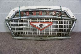 A Vintage 1950’s Bedford Bus Grille, chrome and painted, with central shield logo within pierced