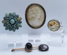 A shell cameo brooch, late 19th century, decorated with a classical female bust, in a white metal