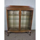 A Georgian style mahogany side cabinet, early 20th century, with a blind fretwork frieze, over two