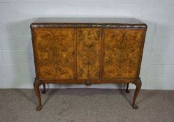 A George II style walnut veneered side cabinet, 20th century reproduction, the moulded top with