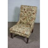 A Victorian mahogany and button upholstered easy chair, with turned front legs and castors