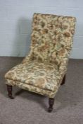 A Victorian mahogany and button upholstered easy chair, with turned front legs and castors