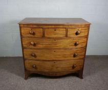 A Victorian bow-front mahogany chest of drawers, late 19th century, with three small drawers over