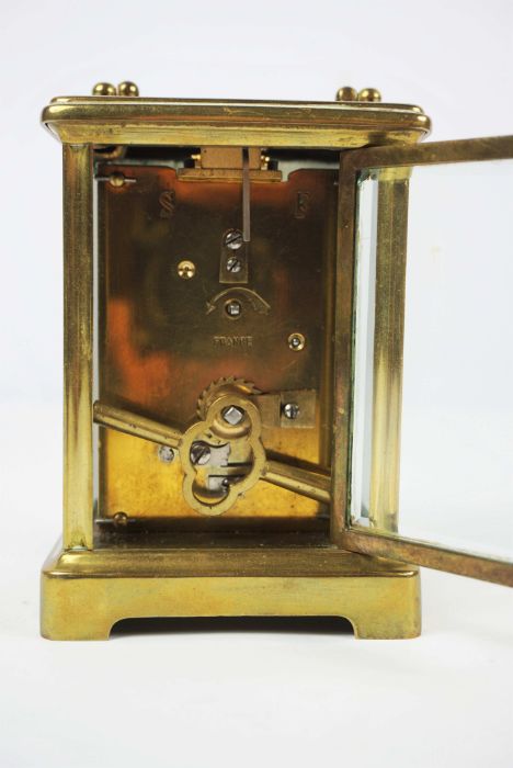 A small brass cased carriage clock, signed Mappin & Webb Ltd, Paris, in a standard plain four - Image 4 of 4