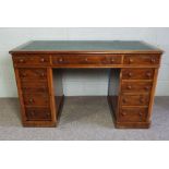 A Victorian mahogany desk, late 19th century, with rounded rectangular top and inset leather writing