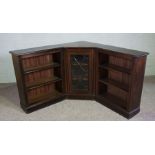 An George III style corner open bookcase, 20th century, with a central glazed corner cabinet flanked