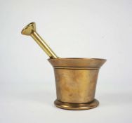 An English brass pestle & mortar, circa 1830, of typical waisted an tapered form, with a flared rim,