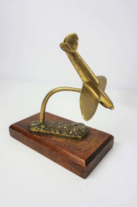 A small brass model of a ‘Spitfire’, possibly a car mascot, circa 1940/50, together with a selection