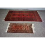 Three assorted rugs, 20th century, one with four medallions on a red ground (3)