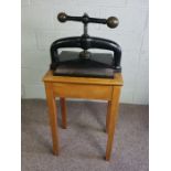 A cast iron and brass press, circa 1900, set on mahogany stand, 115cm high, 50cm wideCondition