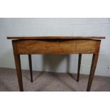 A late George III mahogany dressing table, circa 1800, of serpentine form, the folding top opening