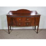 A George III style mahogany sideboard, 20th century, with two drawers and two cabinets on tapered