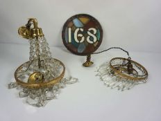 Two cut glass and gilt brass hanging electric light fittings, one with faceted drops radiating