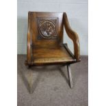 A Victorian oak Glastonbury chair, late 19th century, of typical form, the panelled back inset