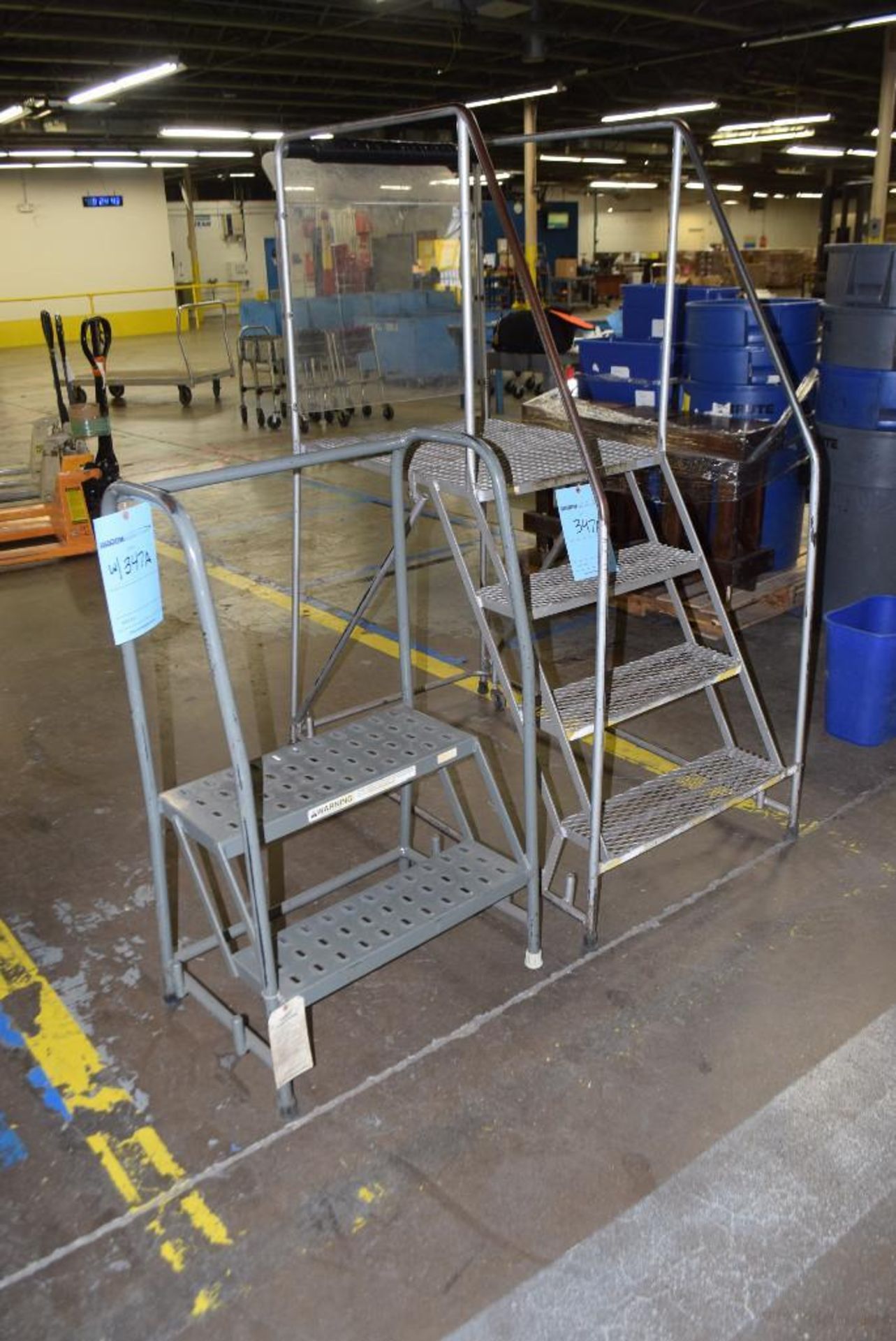 Lot of (2) ladders. (1) portable approximate 4' tall, (1) stationary approximate 2' tall. - Image 2 of 3