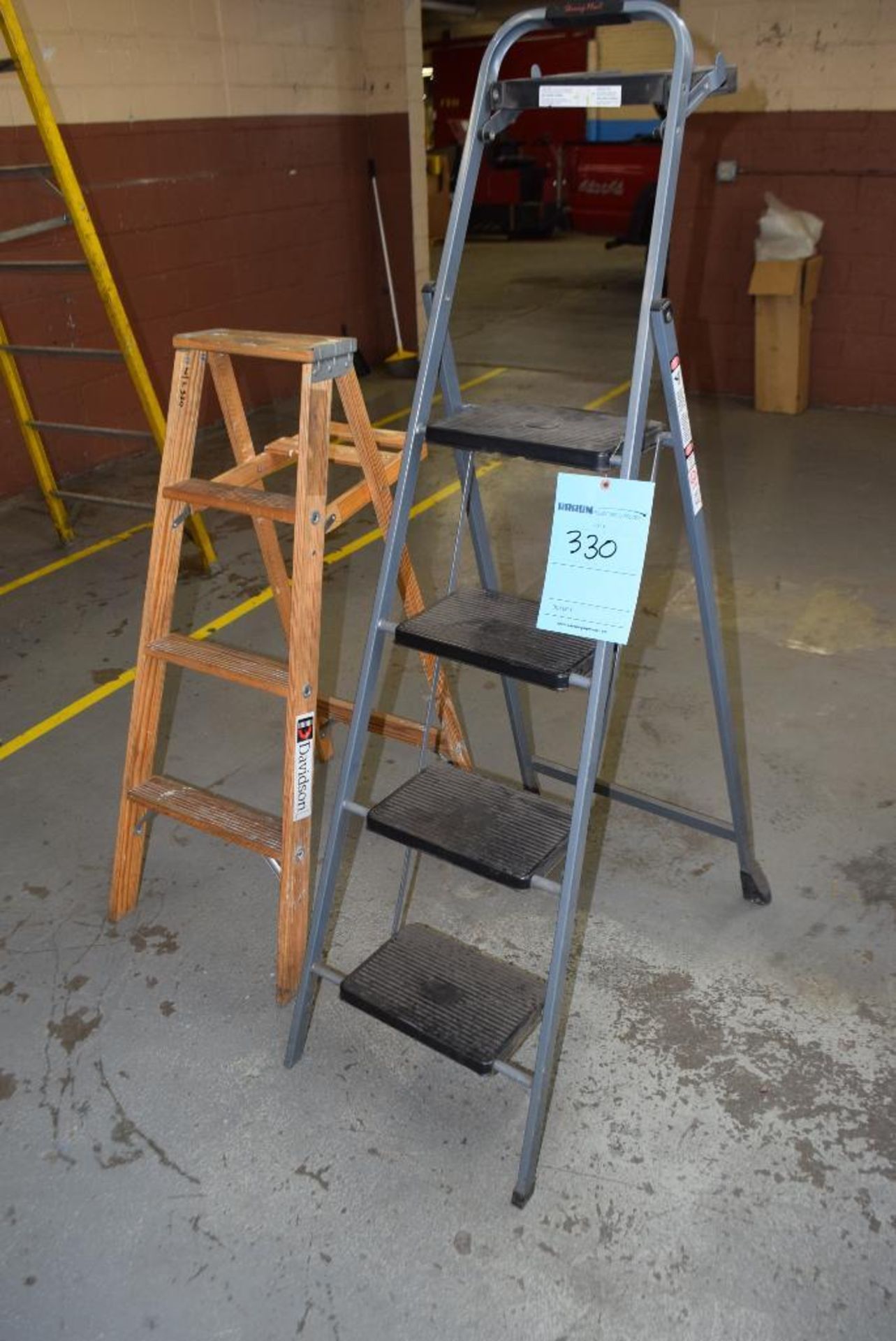 Lot of (2) ladders. (1) wood approximate 4' tall, (1) metal step ladder.