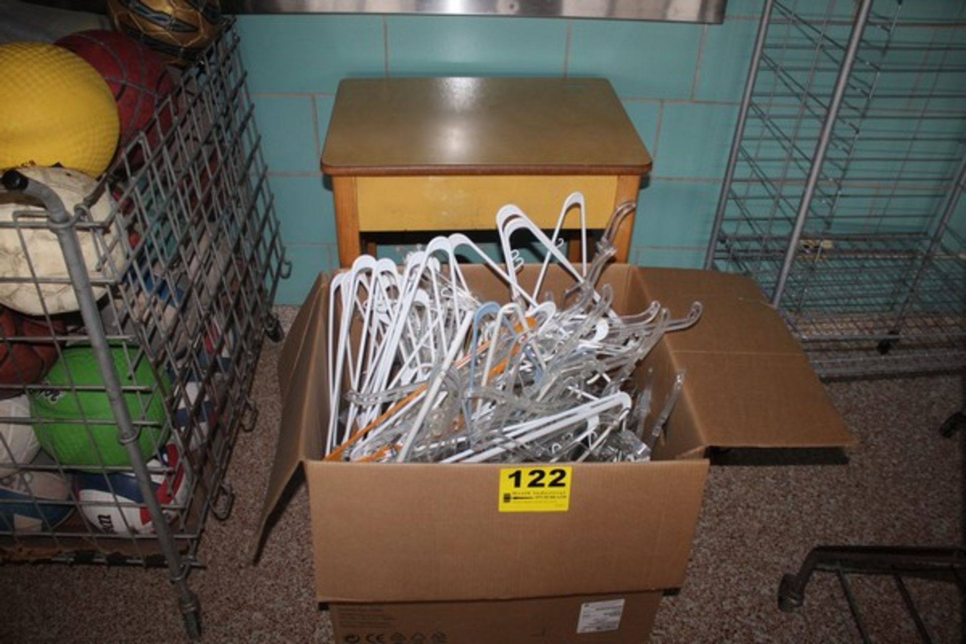 LARGE QUANTITY OF COAT HANGERS AND WOOD TABLE