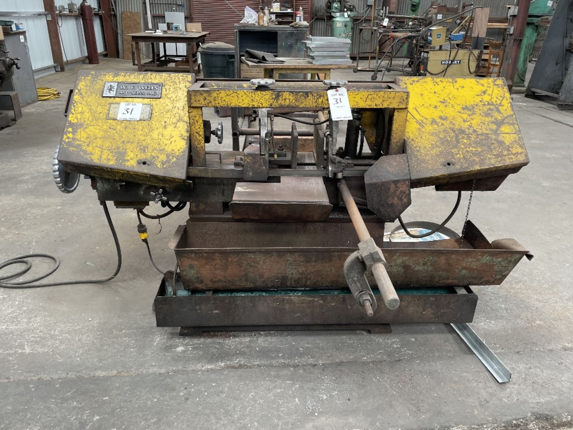 (1) W.F. WELLS AND SONS HORIZONTAL BANDSAW WITH MATERIAL ROLLER AND EXTRA BLADES