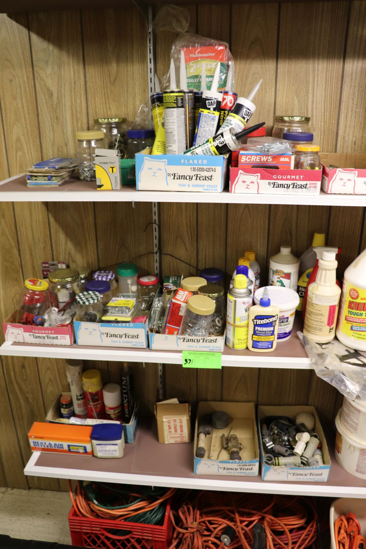 Group: all items on three shelves including caulk, wrenches, fittings, Liquid Wrench, wall covering