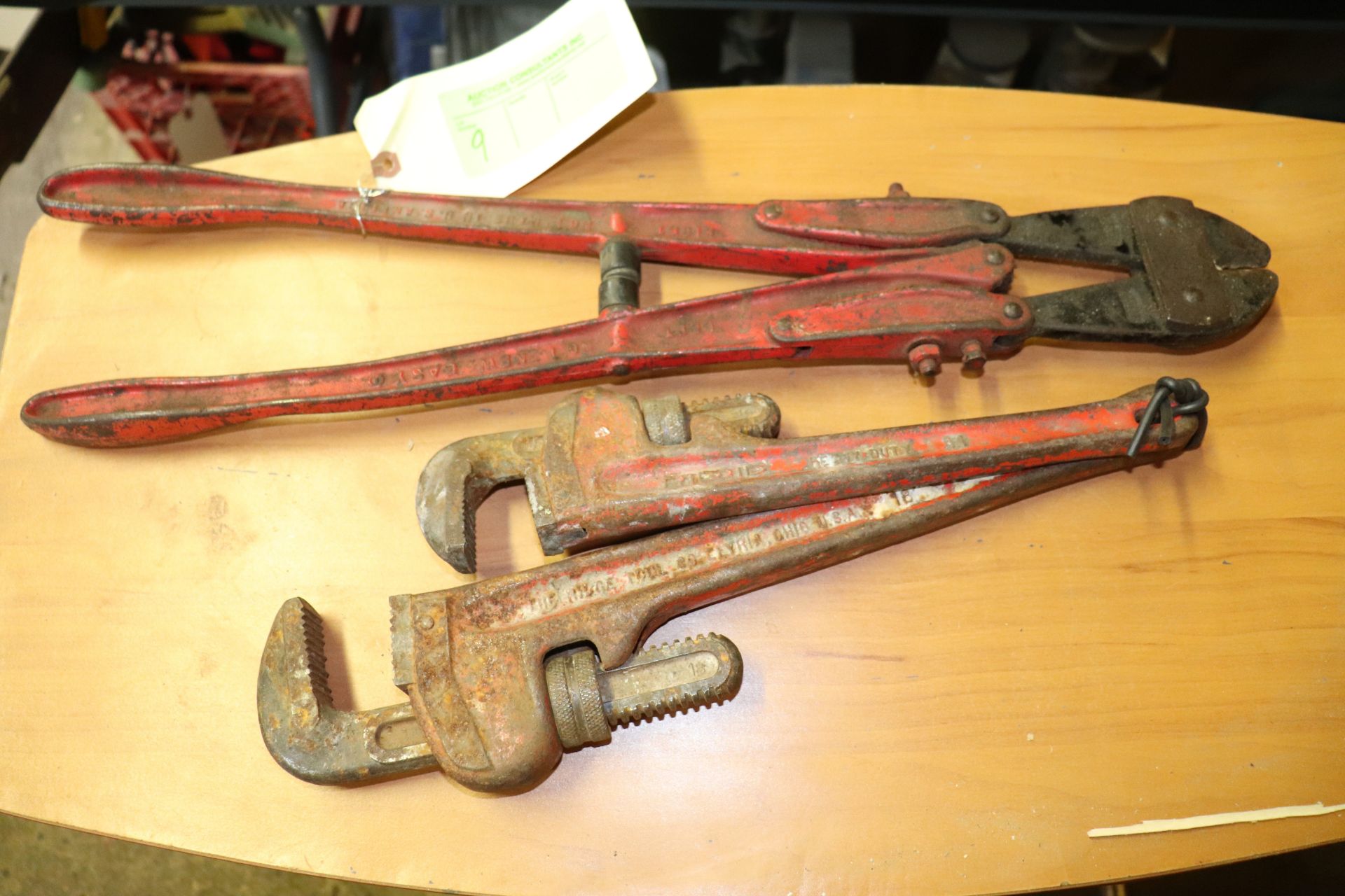 Two pipe wrenches and a bolt cutter