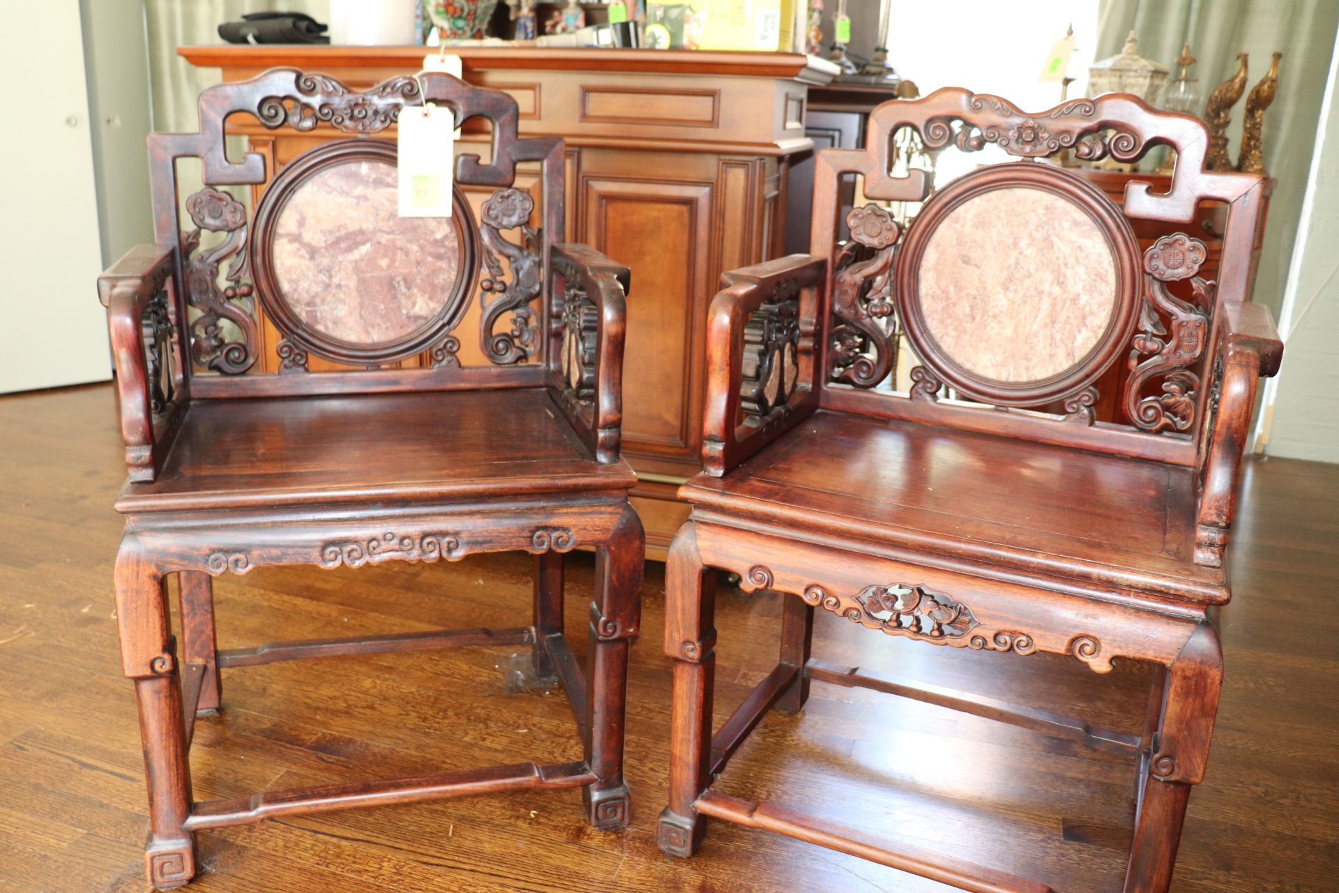 Pair of antique Chinese rosewood armchairs having circular brown marble insert on back, frame having