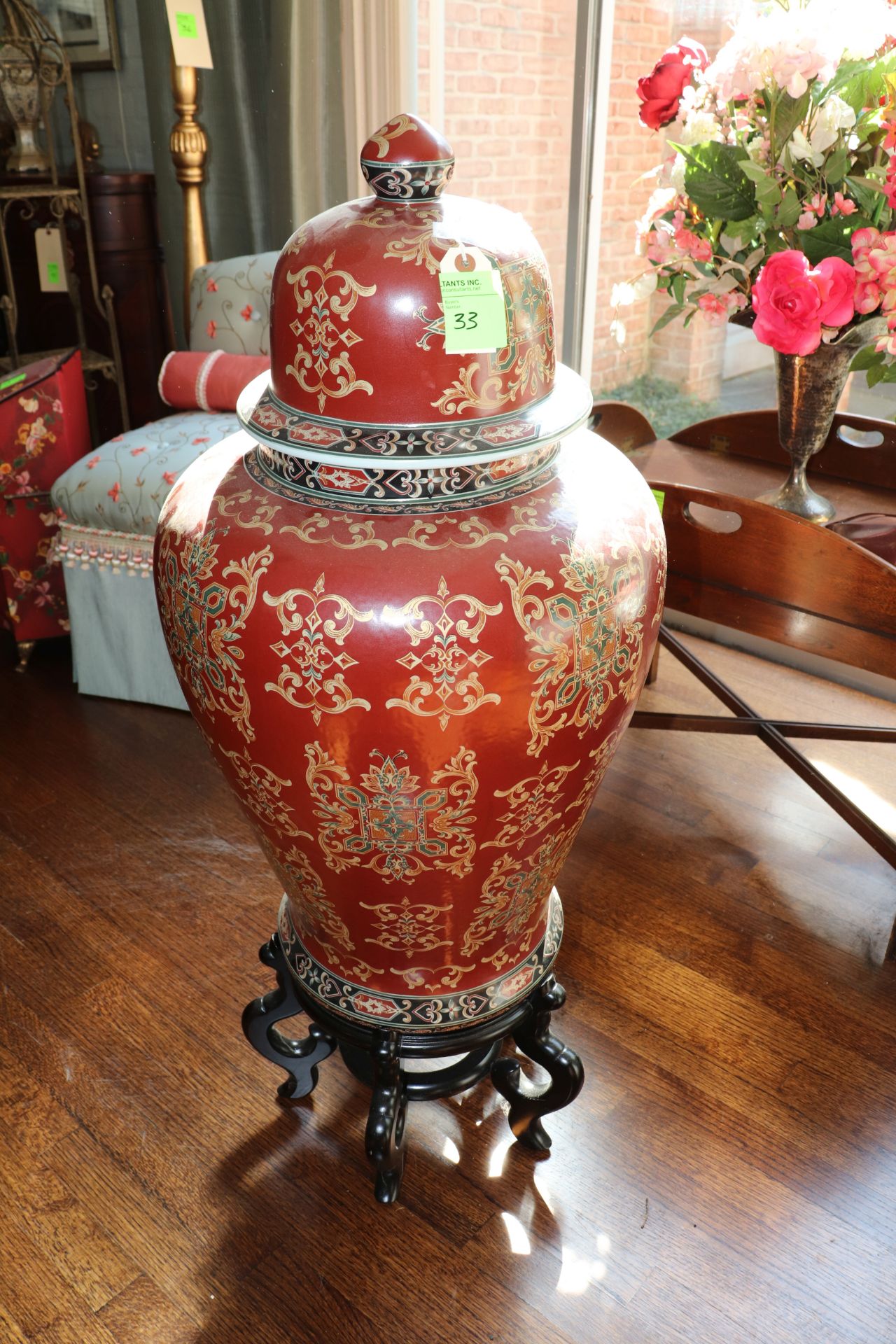 Chinese hardwood stand raised on four legs together with a porcelain planter having floral and leaf