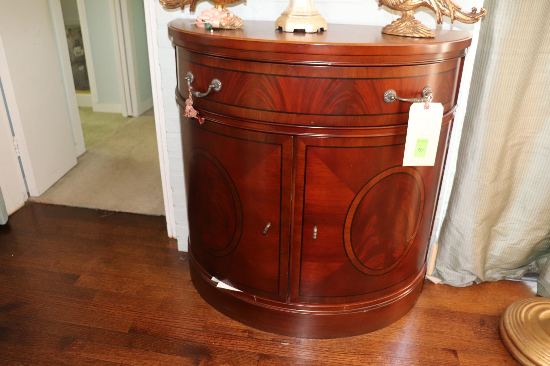 Pair of Georgian style mahogany demilune cabinets, half round top over single drawer over two doors