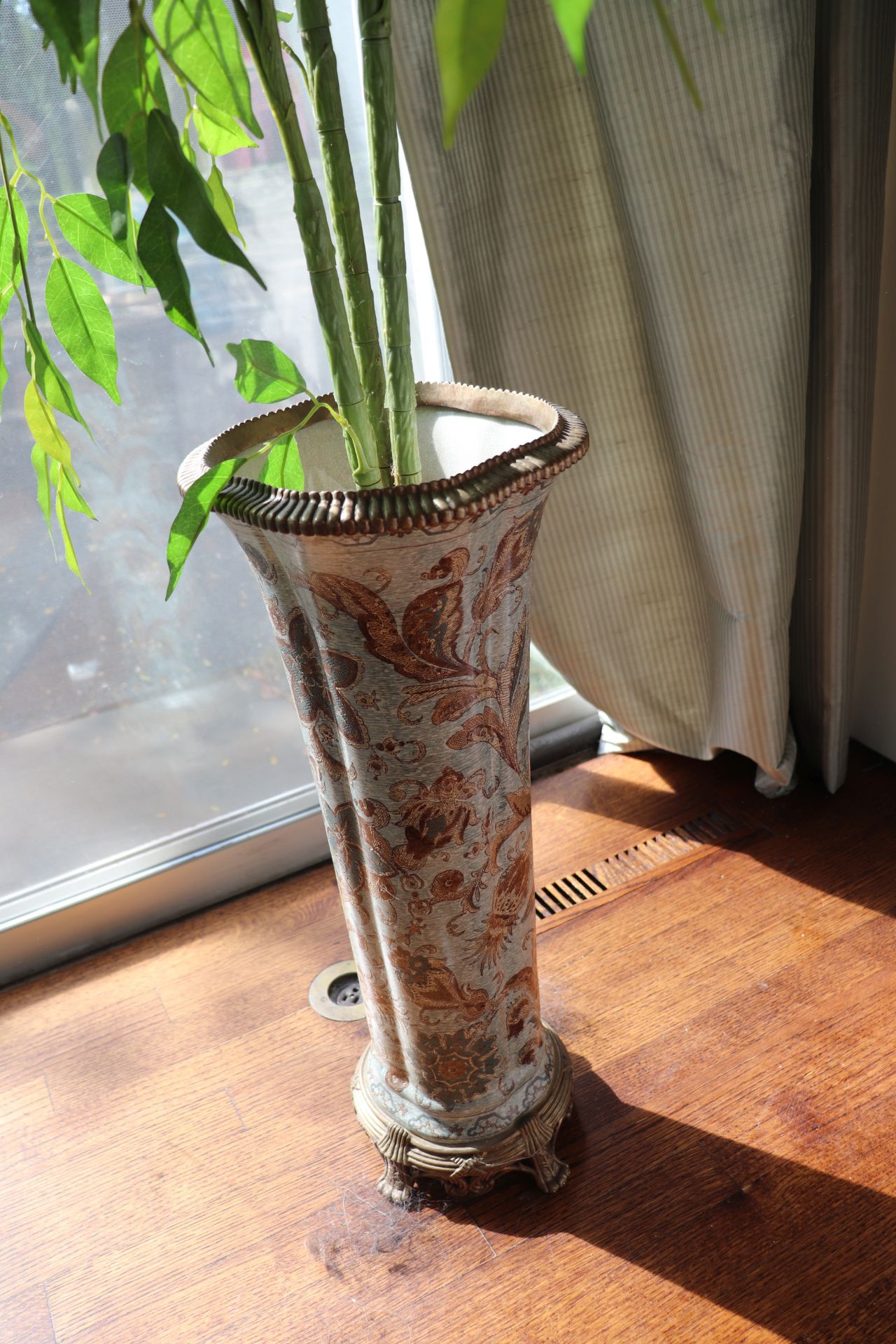 French style porcelain planter having floral and leaf decoration against a greenish gray ground with