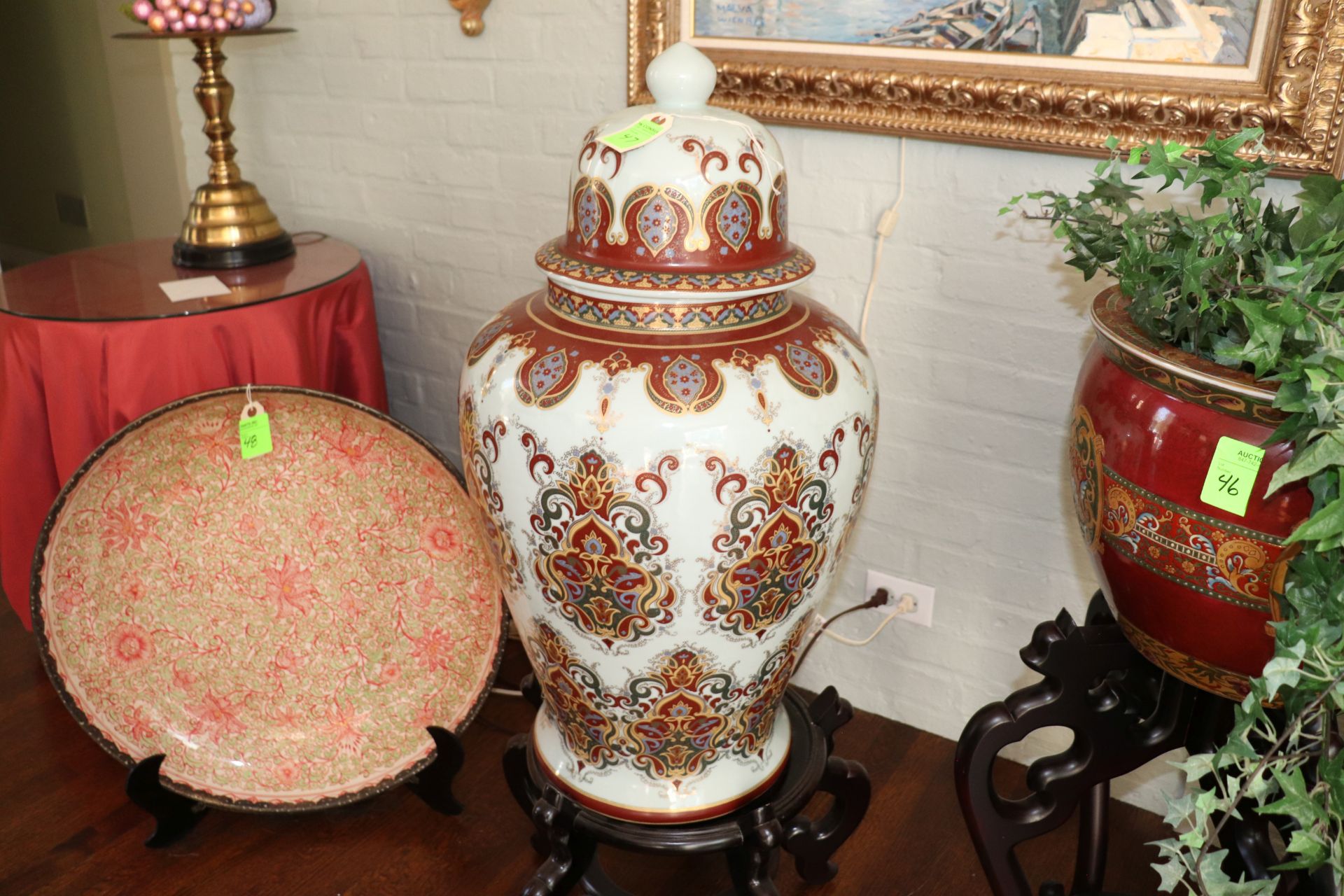 French style porcelain covered urn having floral and leaf decoration against a white ground with gil