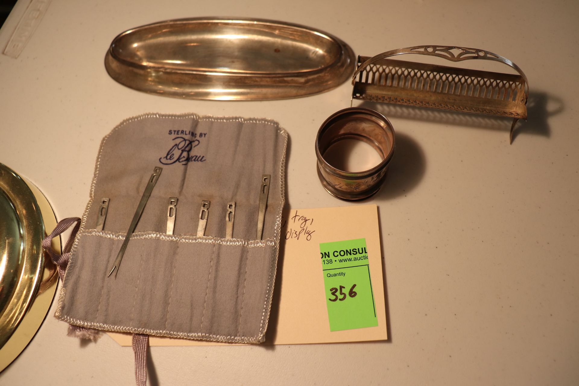 Sterling napkin holder, sterling tray, sterling appetizer forks, 6 pieces, and sterling basket displ