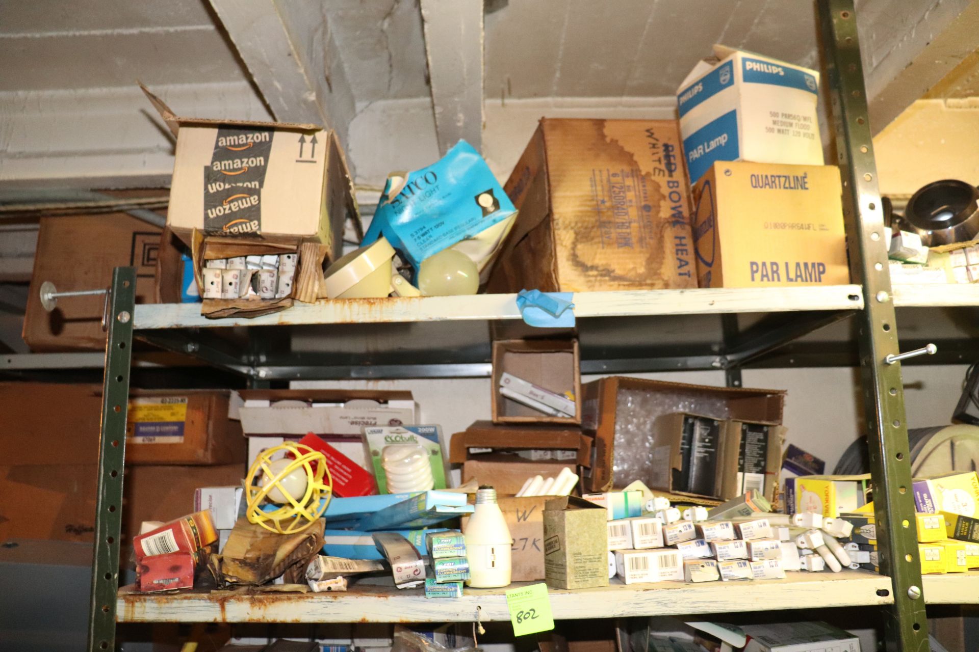 Two shelves of miscellaneous light bulbs