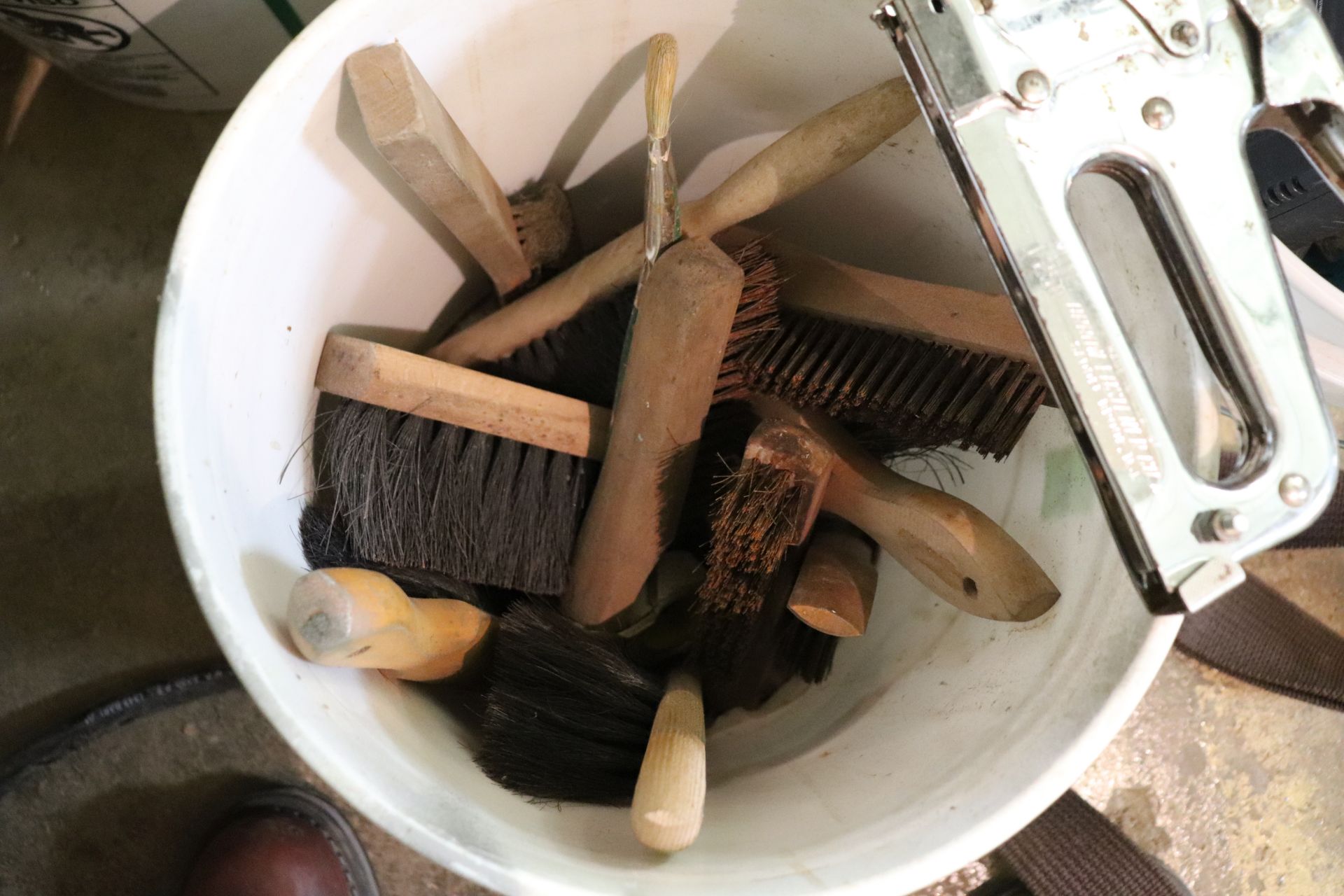 Bucket with brushes and a staple gun