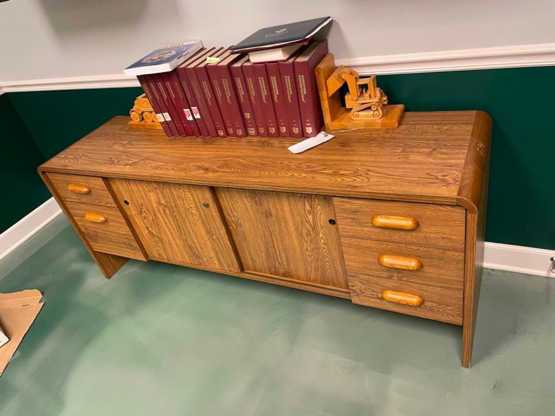 Wood Credenza Storage Cabinet with books. Located in Hazelwood, MO