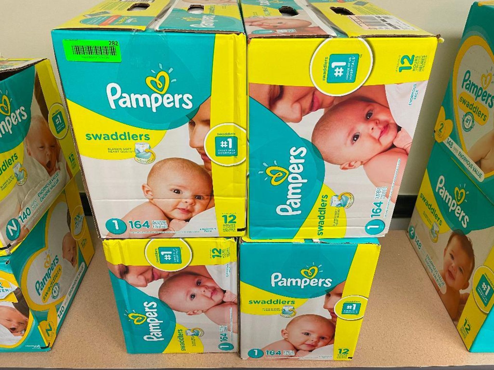DESCRIPTION: (4) BOXES OF PAMPERS SWADDLERS SIZE 1 LOCATION: BASEMENT CONFERENCE ROOM QTY: 4