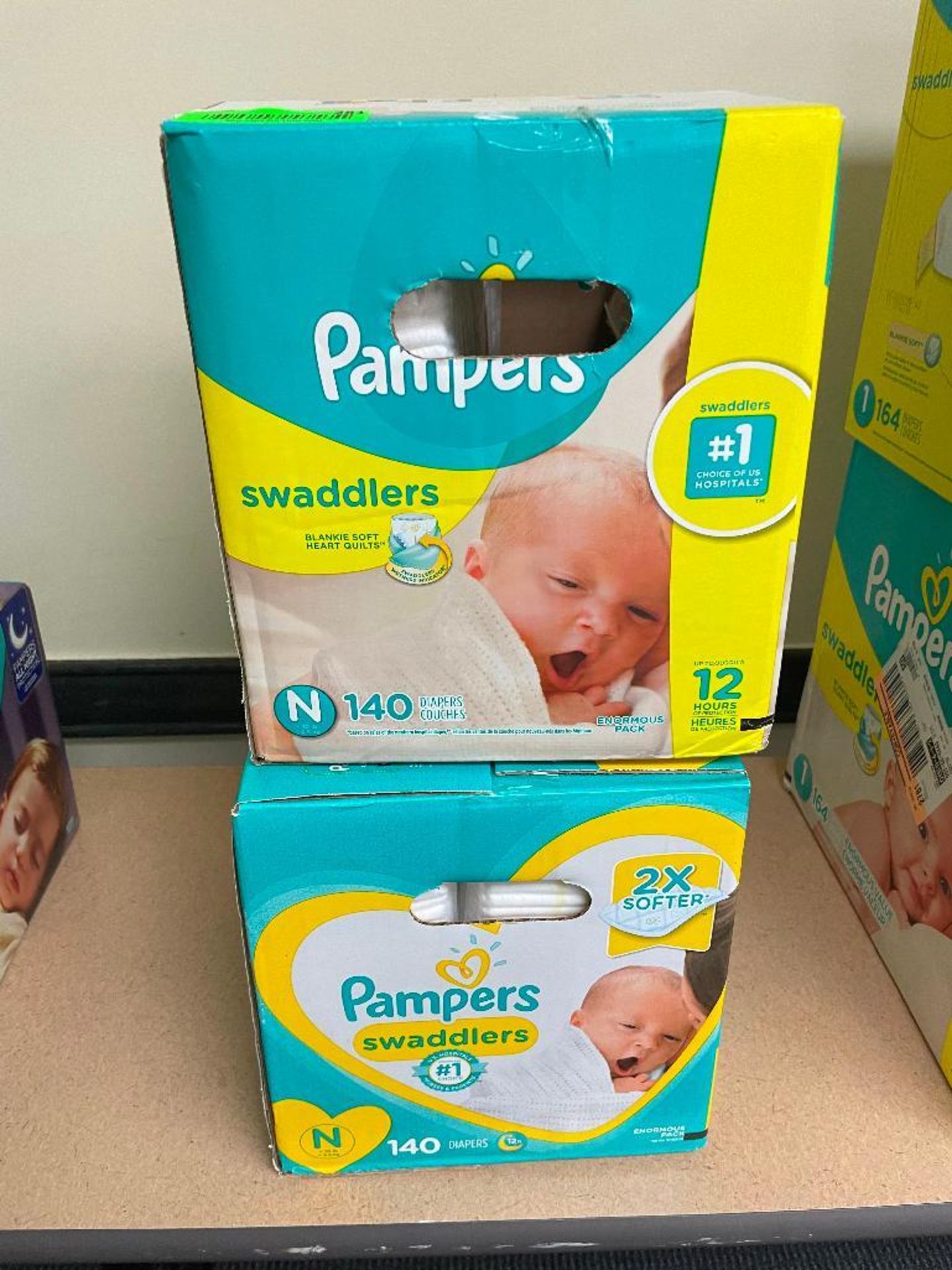 DESCRIPTION: (2) BOXES OF PAMPERS SWADDLERS SIZE N LOCATION: BASEMENT CONFERENCE ROOM QTY: 2