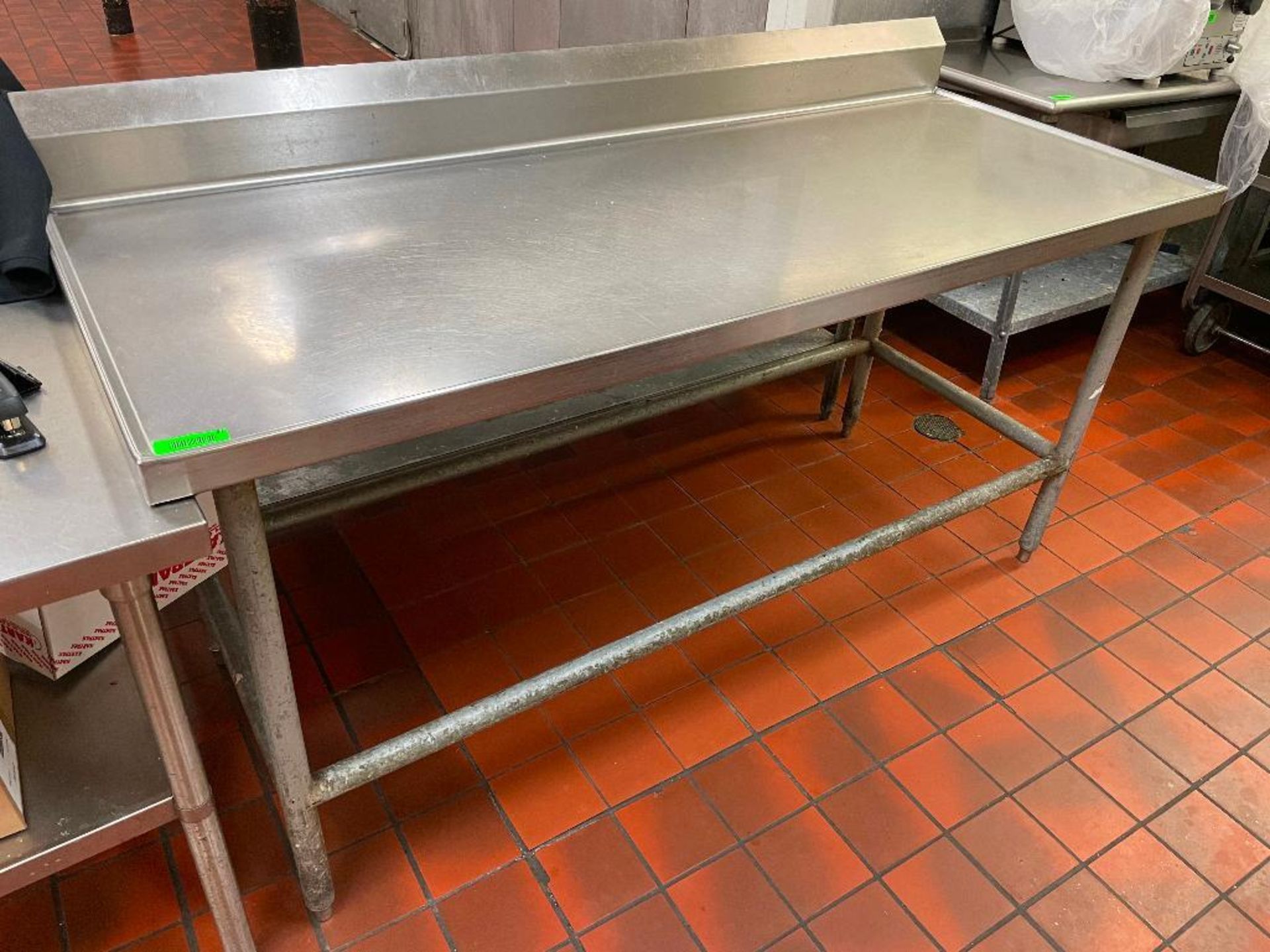 DESCRIPTION: 72" X 30" STAINLESS TABLE W/ 4" BACK SPLASH SIZE: 72" X 30" LOCATION: KITCHEN QTY: 1