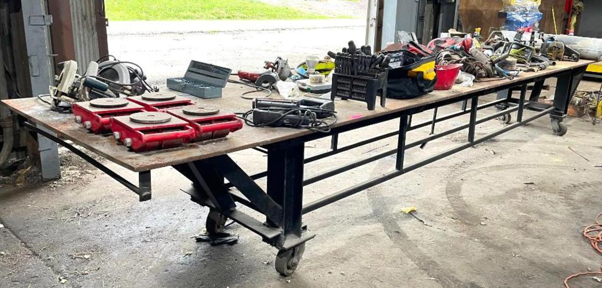 DESCRIPTION 20' STEEL WORK TABLE W/ STEEL FRAME ON CASTERS ADDITIONAL INFORMATION CONTENTS ON TABLE