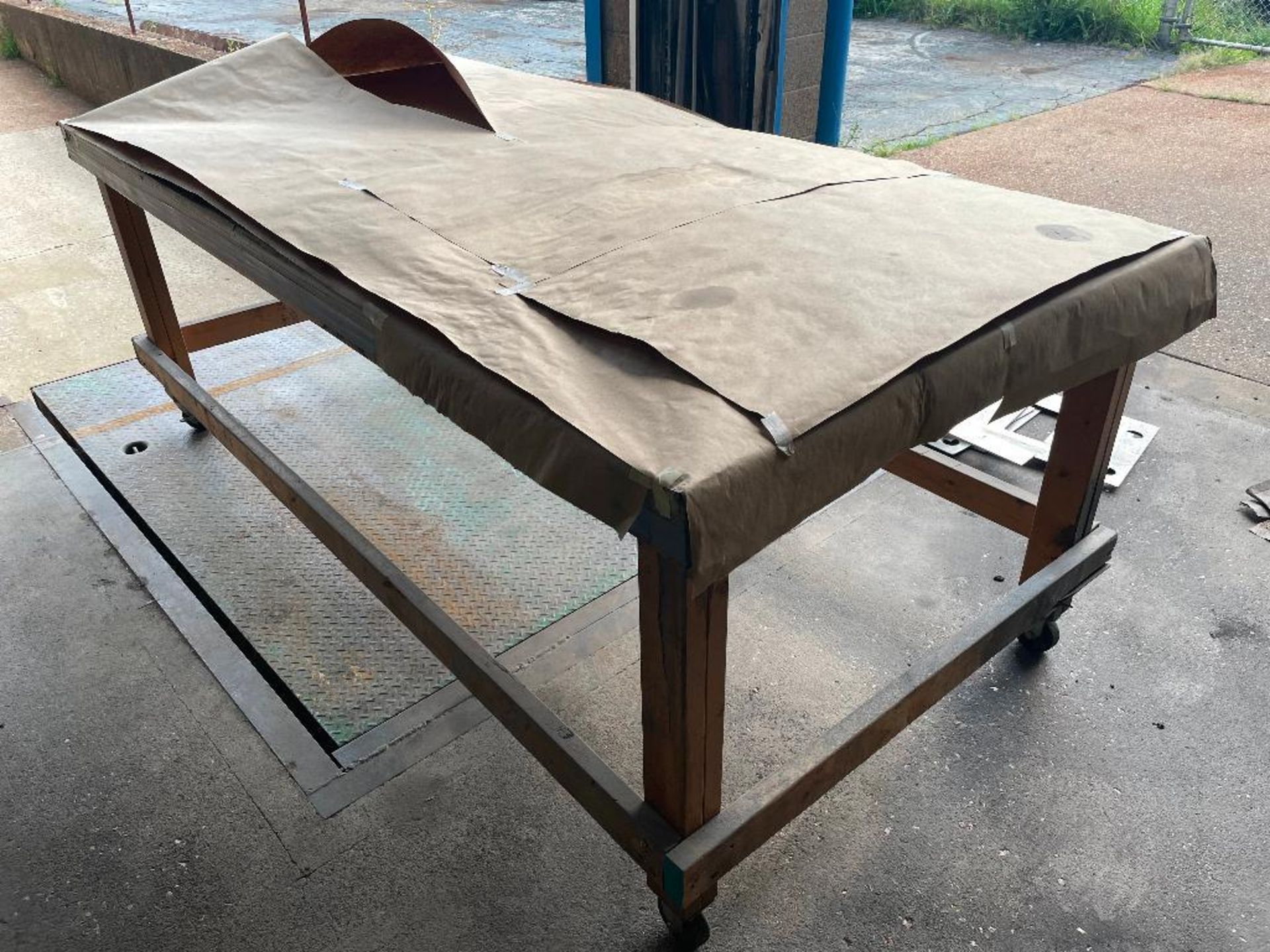 DESCRIPTION: 8' X 3' WOODEN FABRICATION TABLE ON CASTERS ADDITIONAL INFORMATION NO CONTENTS SIZE: 8'