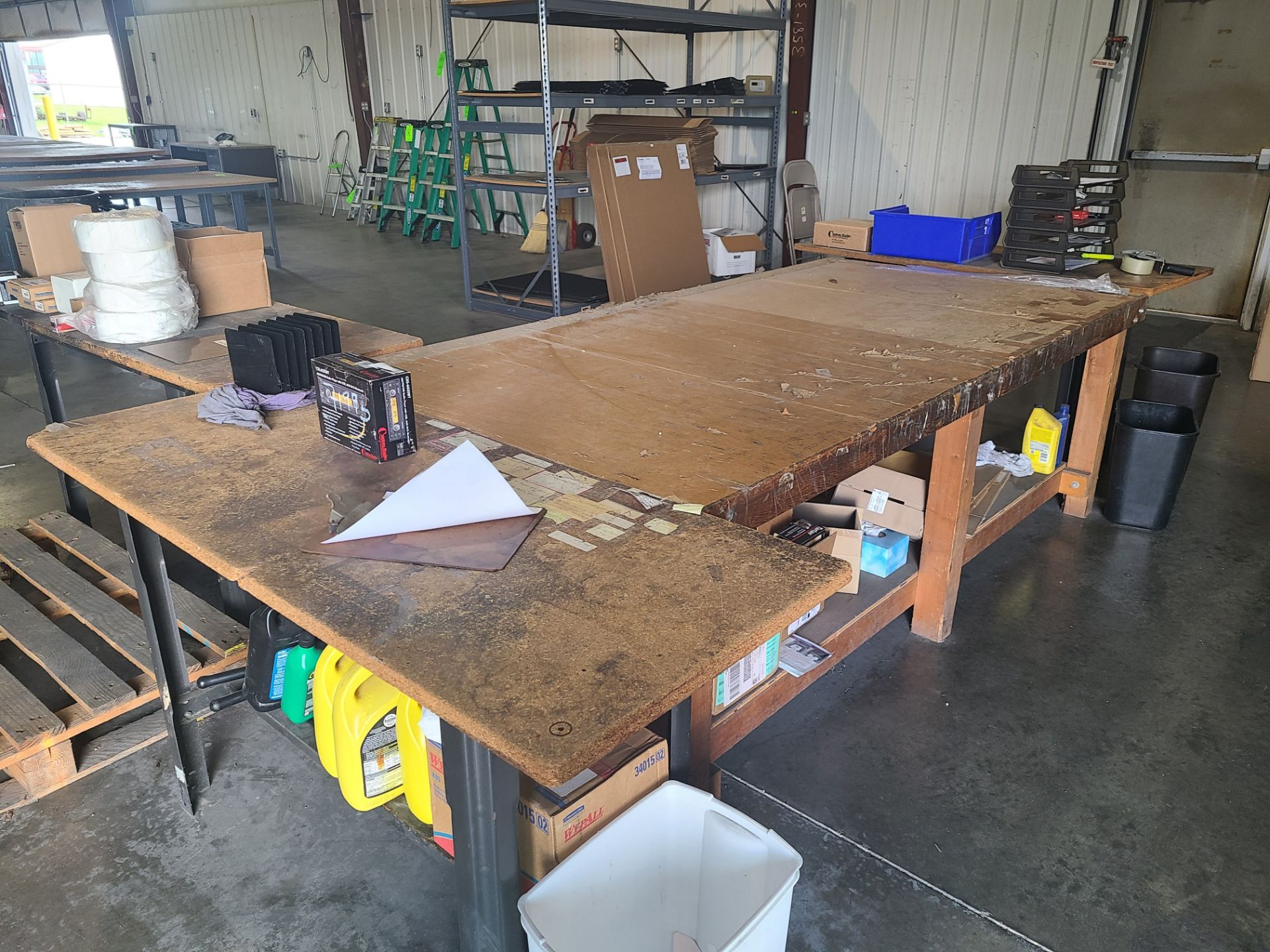 (3) STEEL TABLES WITH PARTICLE BOARD TOP 5'X2' ; (1) WOOD TABLE 8'X4'