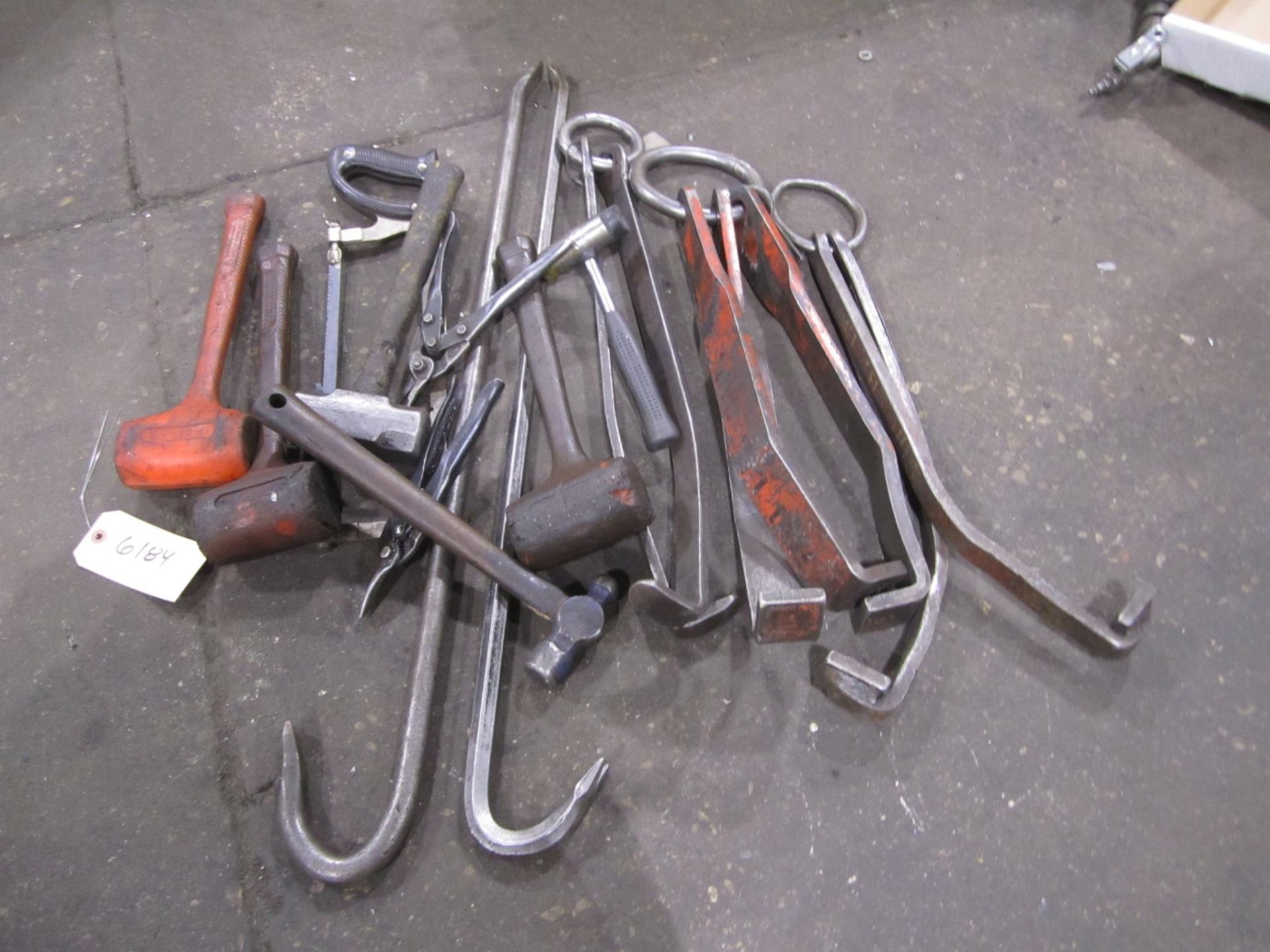 Assorted tools to include: Hammers, saws, snips, crow bars, lifting assemblies