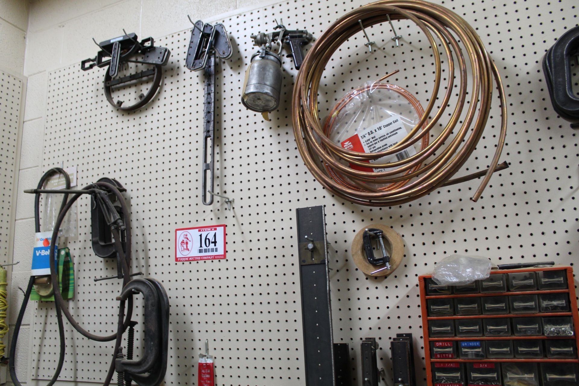 Contents of Peg Board: C-Clamps, Saws, Belts, Paint Gun, Flexible Copper Tubing, Etc.