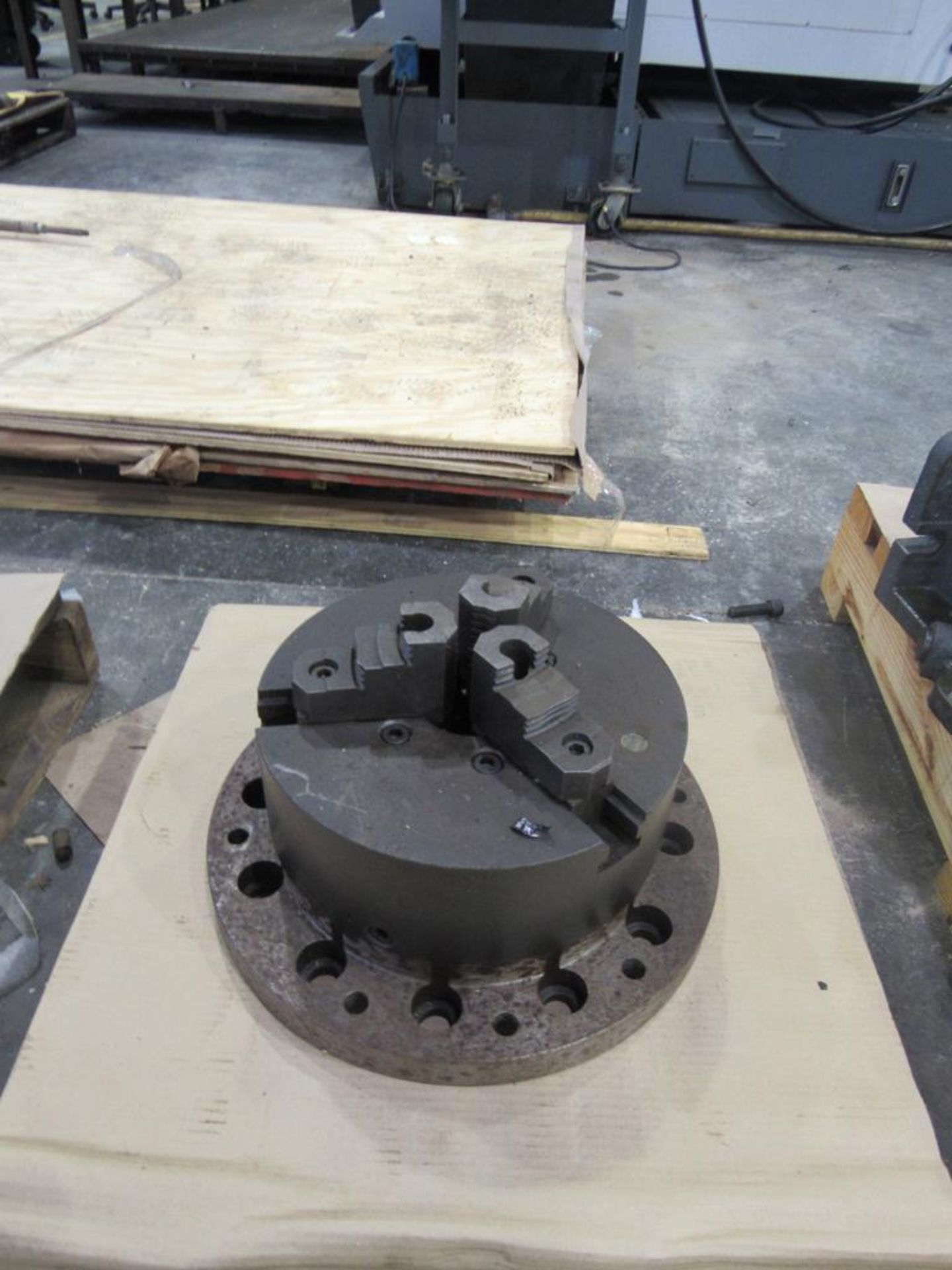 12" 3-Jaw Buck Chuck with 3" Thru-Hole mounted on custom 16" base; 12 holes, 1-1/4" with 3/4" dia.