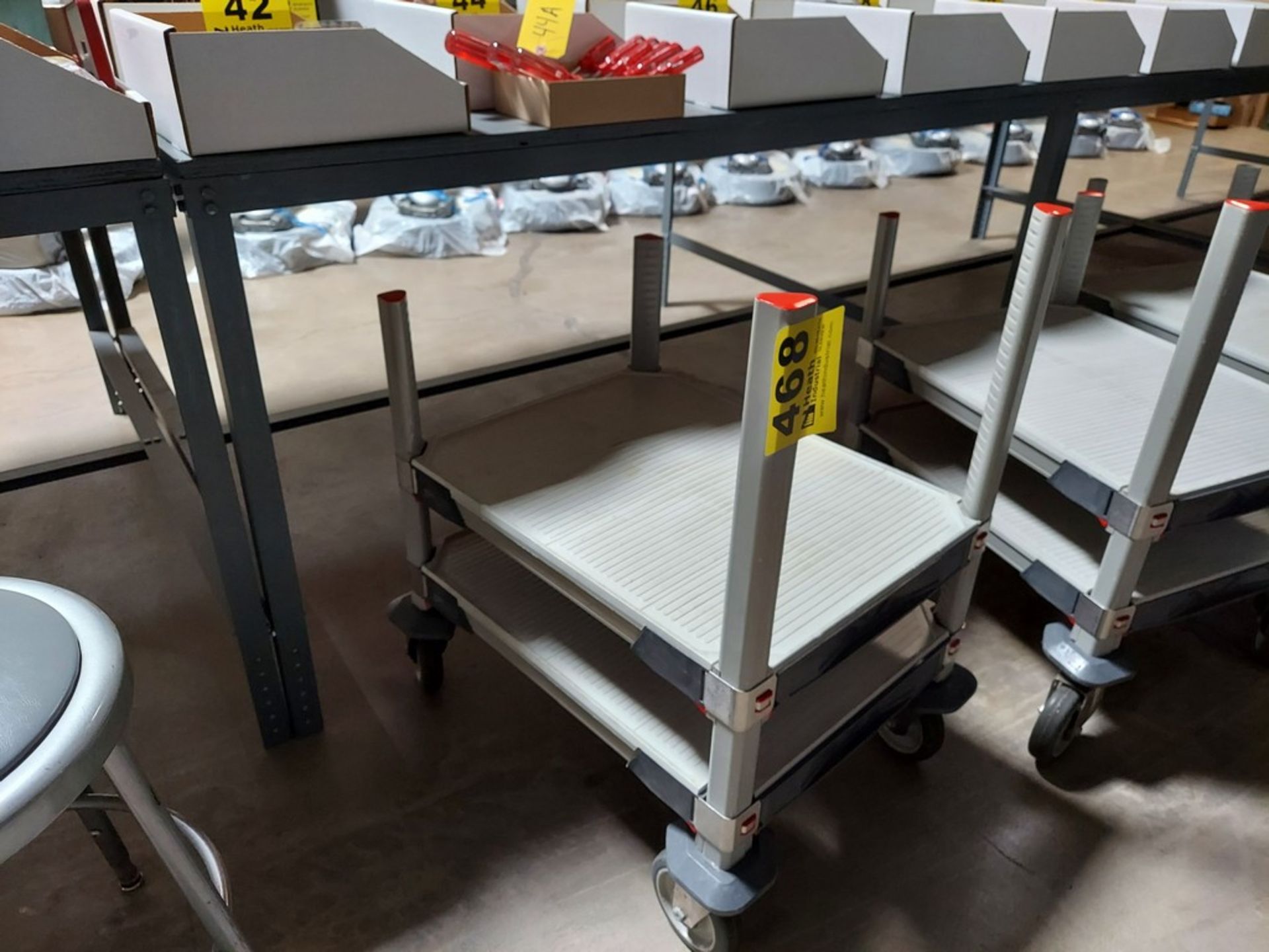 PLASTIC SHOP CART WITH ADJUSTABLE HEIGHT TOP SHELF AND CASTER WHEELS