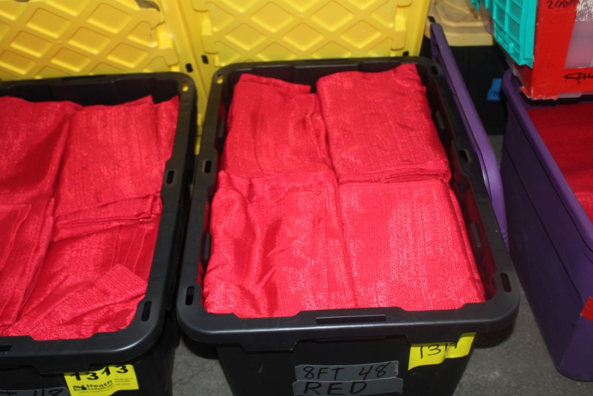 APPROX. (48) 8FT RED DRAPES IN TOTE ( QUANTITIES NOT GUARANTEED)