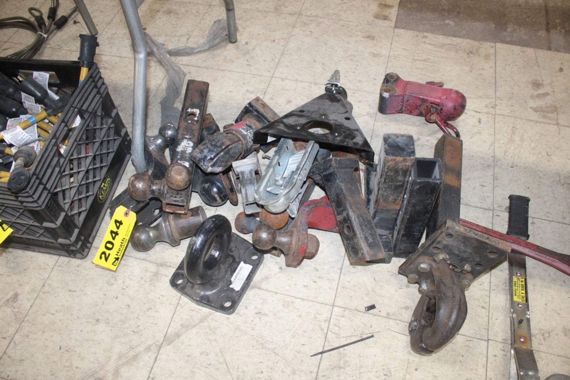 ASSORTED TRAILER HITCHES AND BALLS ON FLOOR