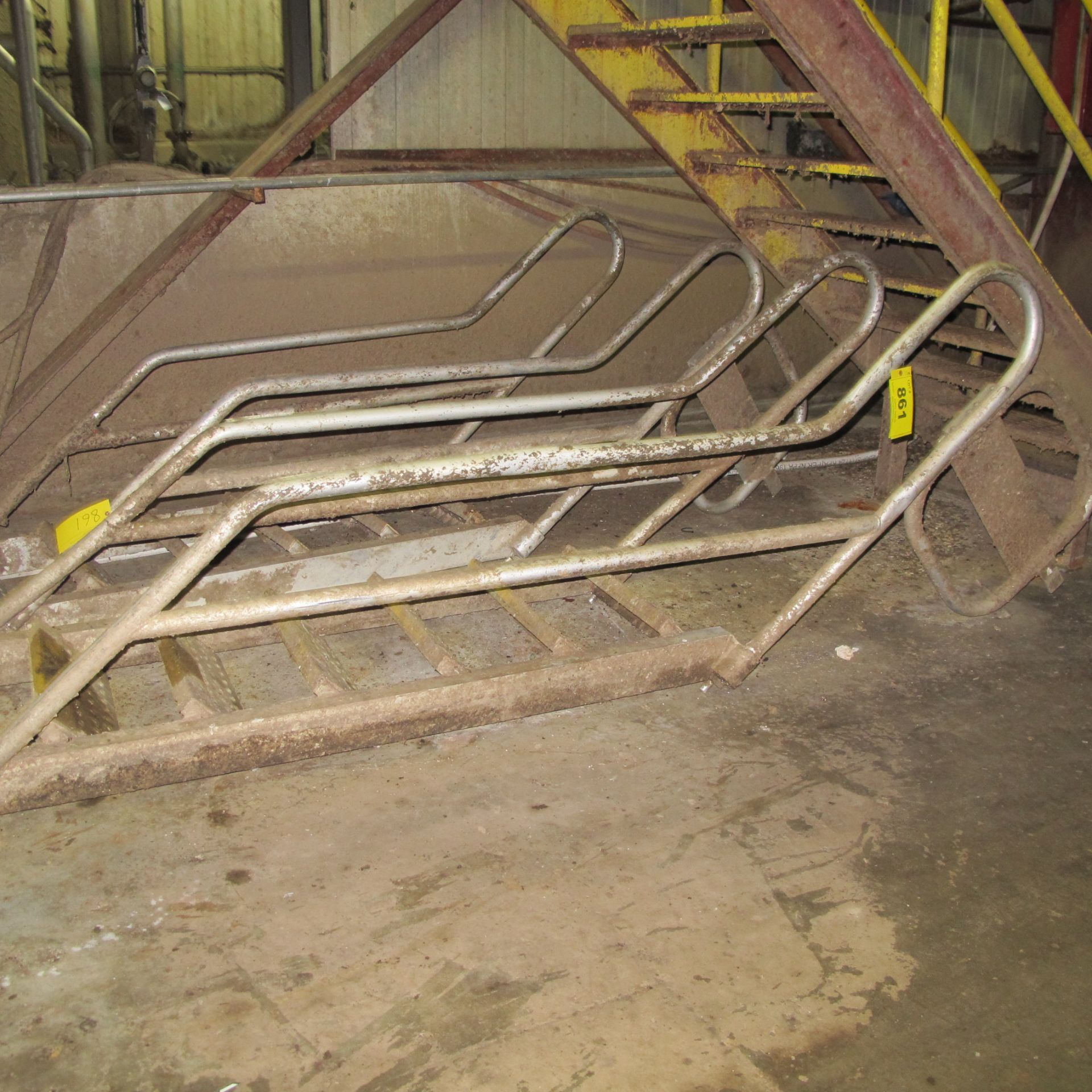LOT OF (2) STAIRCASES AND (2) METAL HORSES (WEST BUILDING, GROUND LEVEL/BASEMENT UNDER PAPER