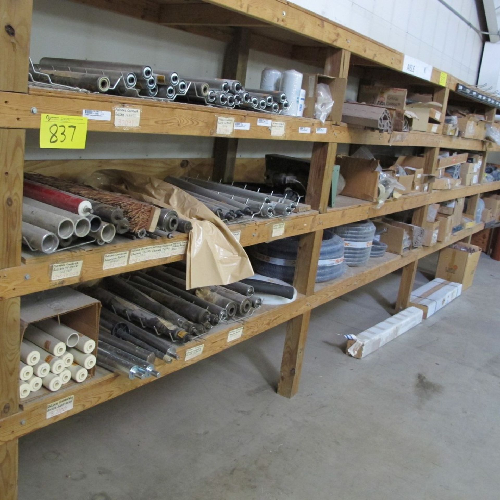 LOT OF (4) SECTION WOODEN RACK, 5-LEVELS TALL W/ ASST. METAL ROLLERS, HOSES, BELTS, CABLES, MOTOR,