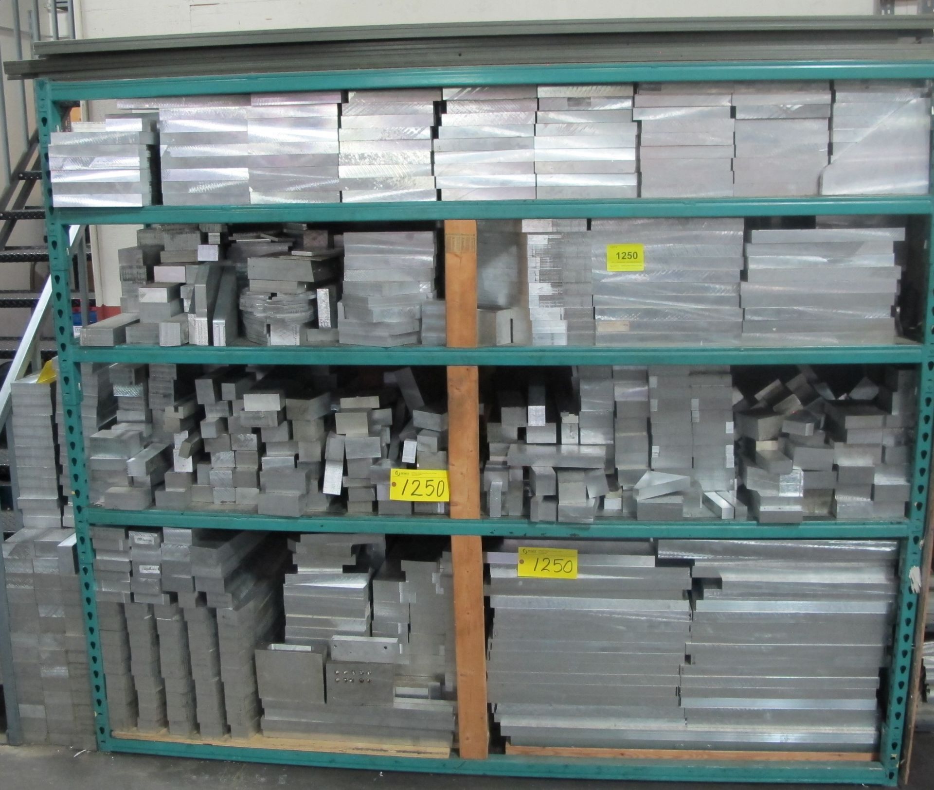 ALUMINUM STOCK CONTENTS ON 5-LEVEL RACK W/ METAL ON SHELF ON RIGHT OF RACK AND METAL BLOCKS BESIDE