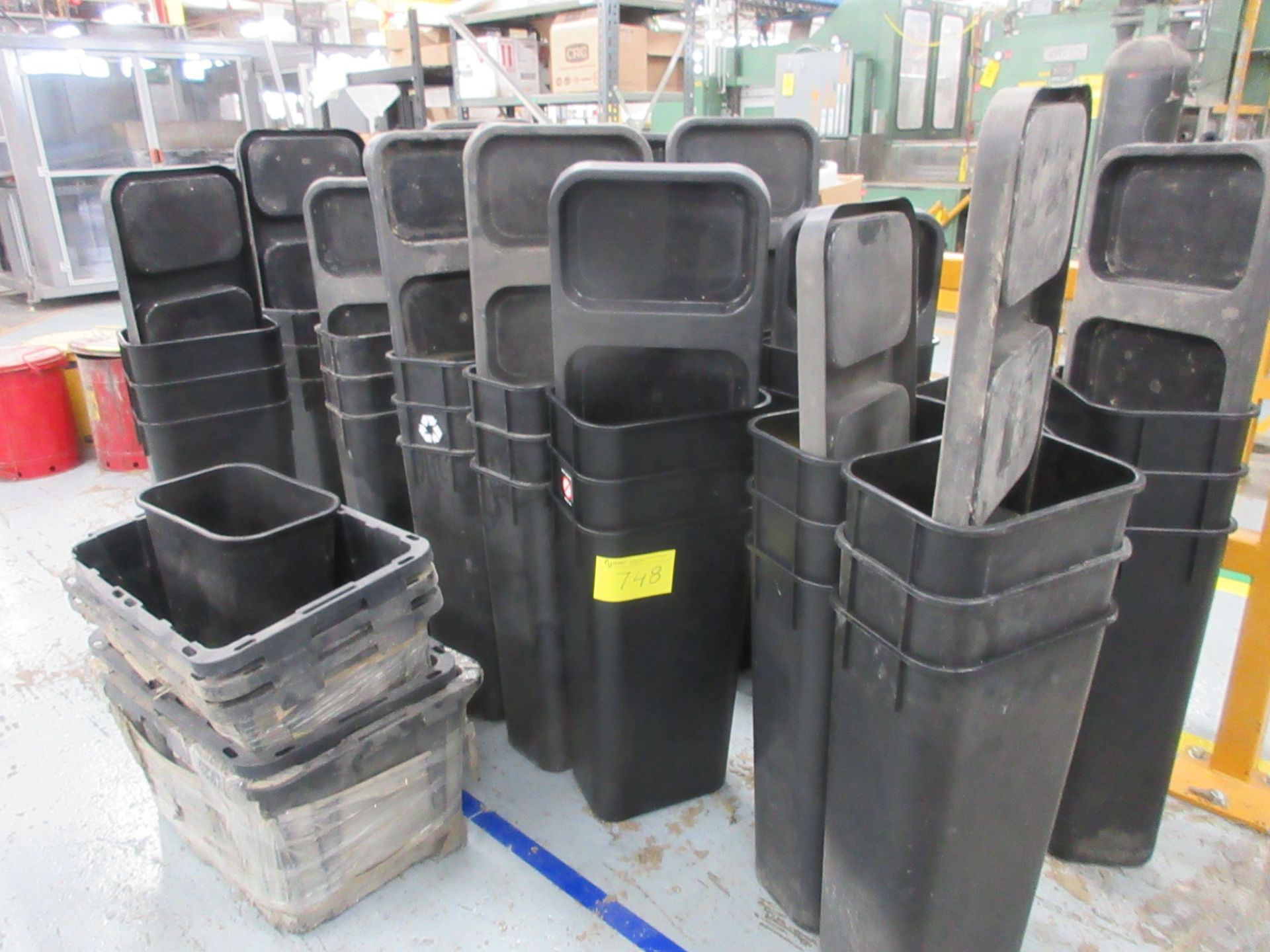 LOT OF BLACK GARBAGE CANS W/ TRIPLE BASES (SOUTH CENTRAL PLANT)