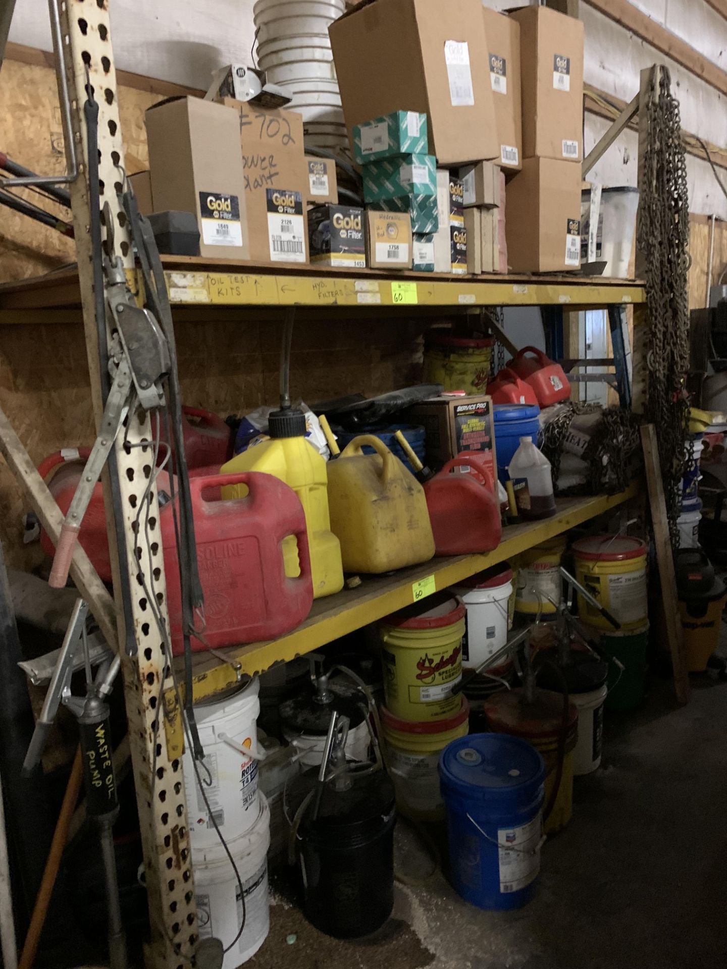 Contents of Racking - Gas cans, oil cans, chain, filters, pumps for 5 gal buckets.